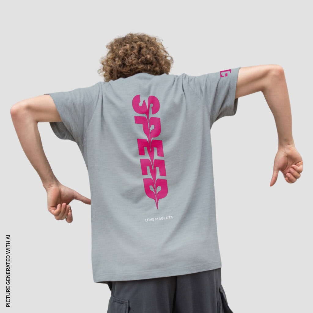 Rear view of a man wearing the T 5G SPEED T-SHIRT. The vertical, bright magenta “SPEED” lettering is clearly visible.