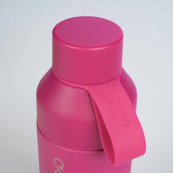 A close-up of the LOVE MAGENTA OCEAN BOTTLE with its vibrant magenta hue
