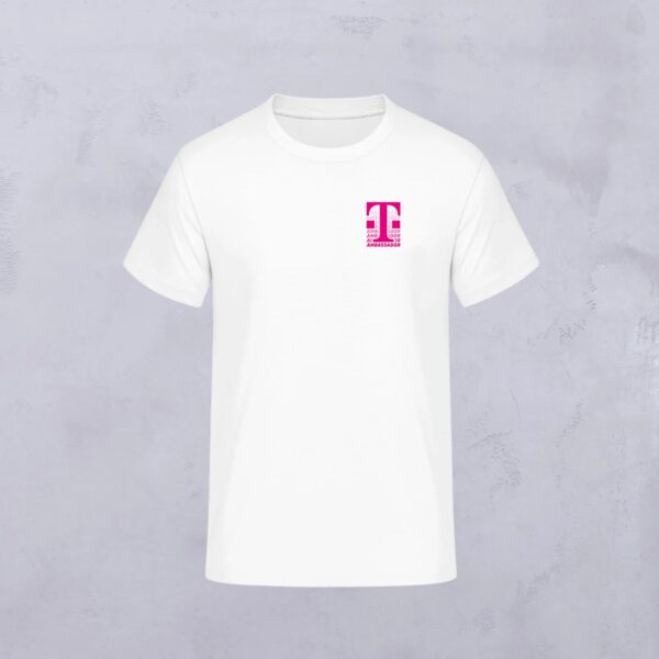 The AMBASSADOR T-SHIRT WHITE features a small magenta “T” logo with “Magenta” underneath on the left chest on a light gray, textured background.