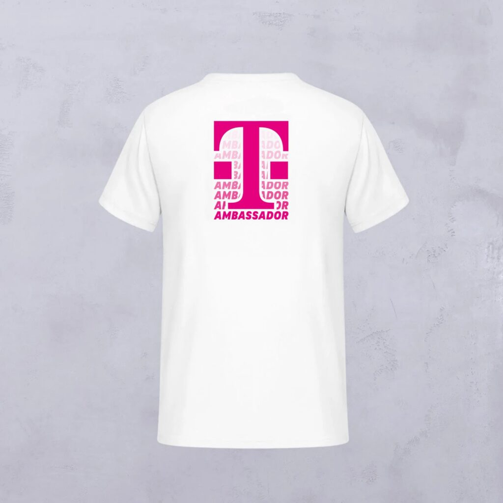 Ein weißes T-Shirt mit einem rosa Aufdruck auf der Rückseite, auf dem das Wort „AMBASSADOR“ in fetten Großbuchstaben wiederholt wird und ein rechteckiges Motiv bildet – ein typisches Merkmal von Ambassador Designs.
